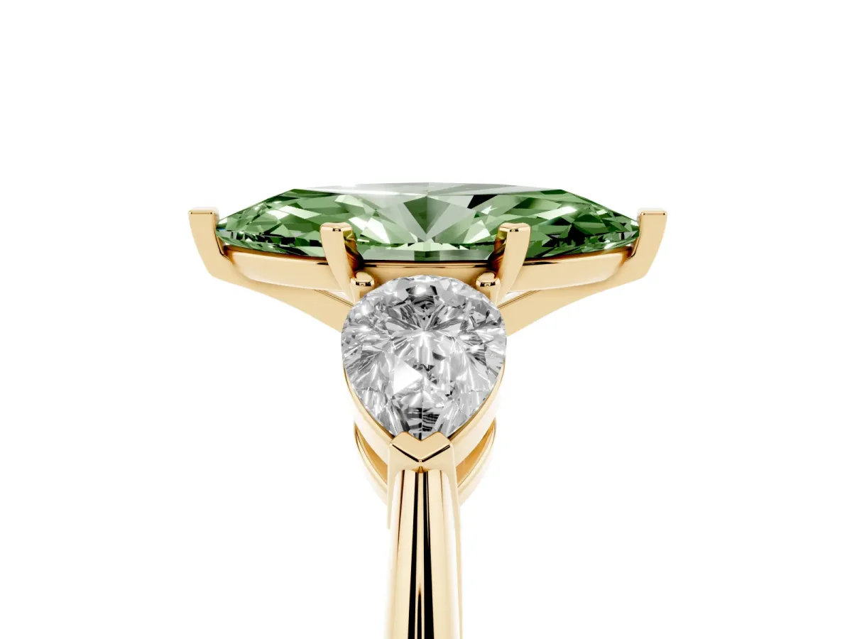 Fancy Green Three-Stone Marquise Cut Diamond Ring with Pear Side Stones and Four-Prong Setting Yellow gold