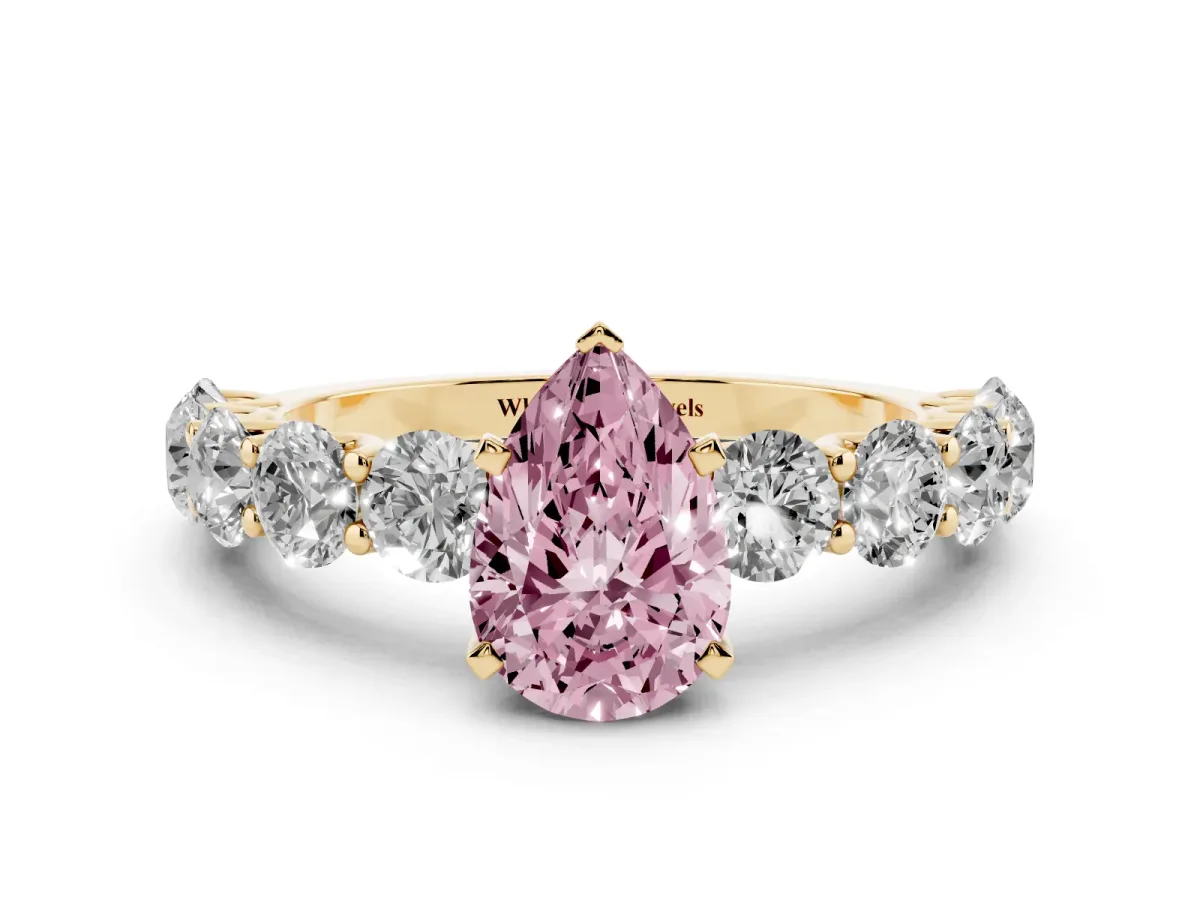 Fancy Pink Pear Cut Diamond Prong Setting with Side Stones on a Pave Band Yellow gold