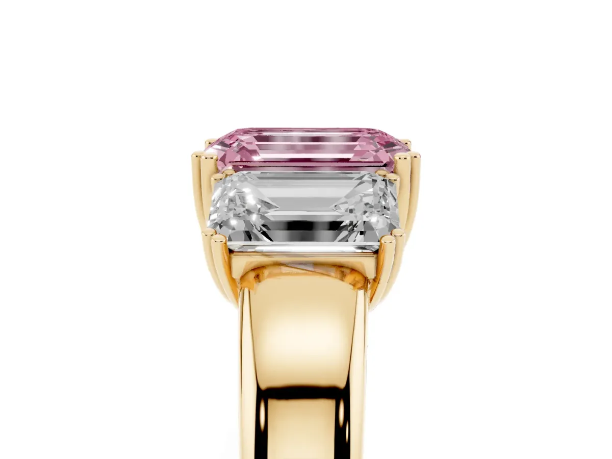 Fancy Pink Three-Stone Emerald Cut Cut Diamond Ring with Channel Set Band and Four-Prong Setting Yellow gold