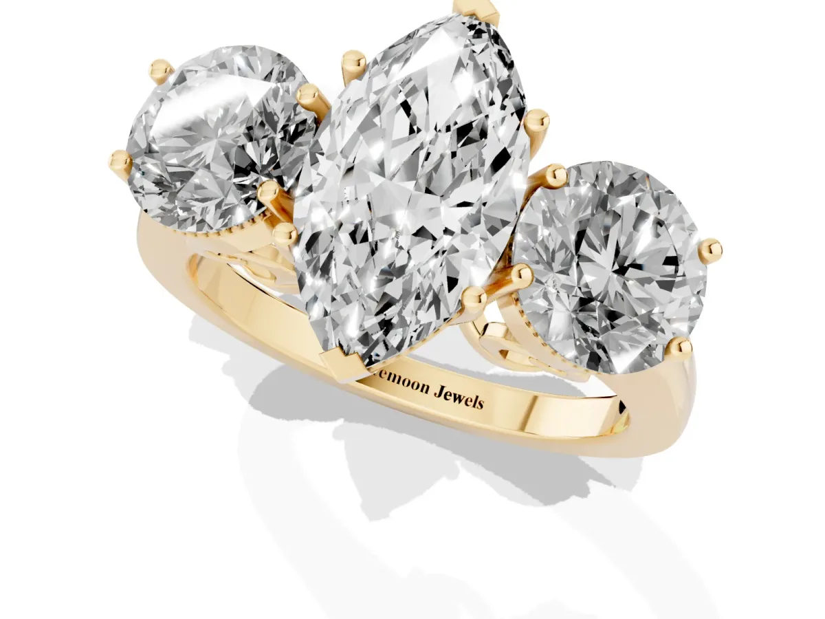 Three-Stone Marquise Cut Diamond Engagement Ring with Prong Setting on a Classic Band Yellow gold
