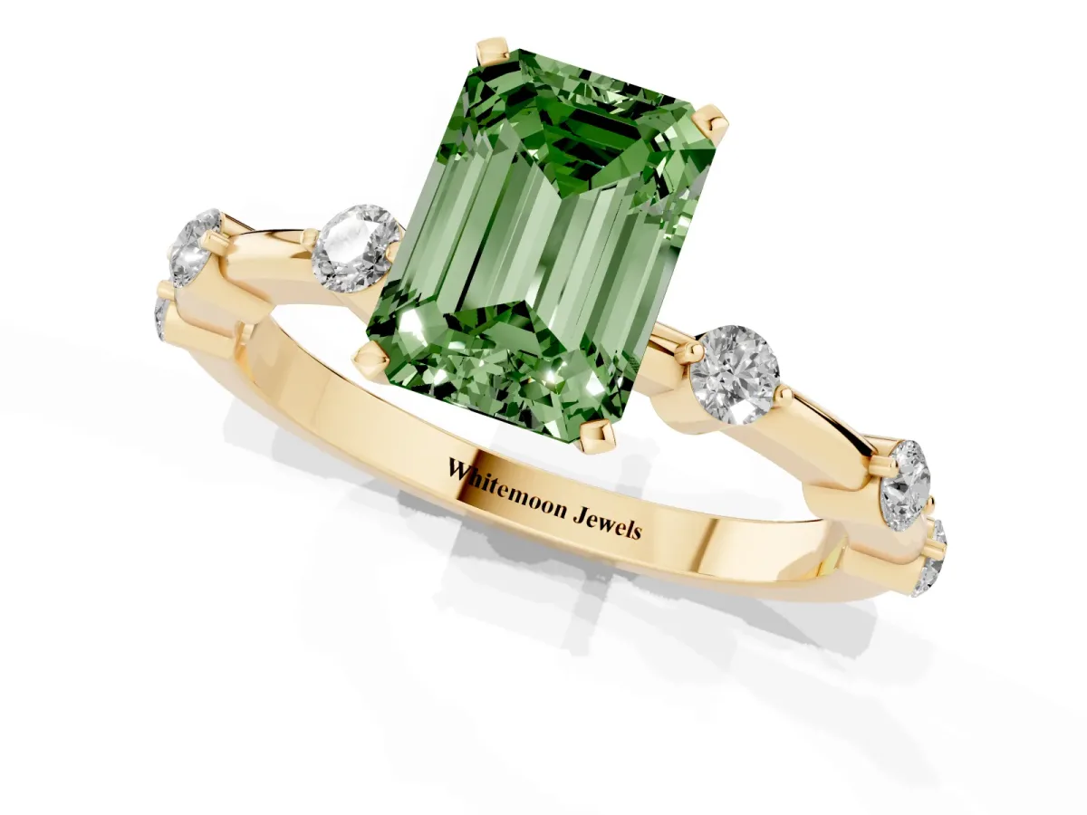 Fancy Green Emerald Cut Solitaire Diamond Ring with Bezel Set Side Stones and Prong Setting Yellow gold