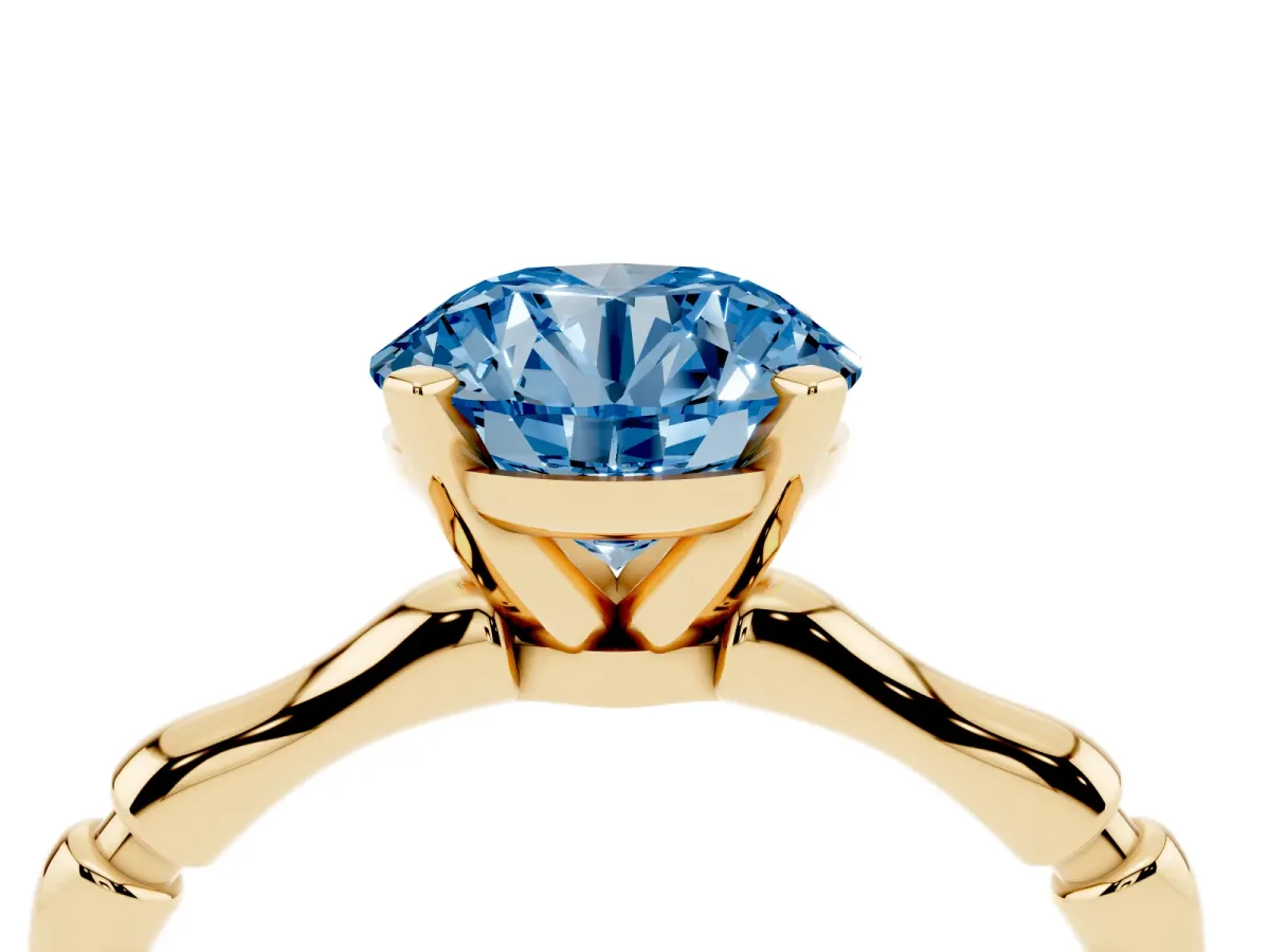 Fancy Blue Round Cut Solitaire Diamond Ring with Bamboo Band and Four-Prong Setting Yellow gold