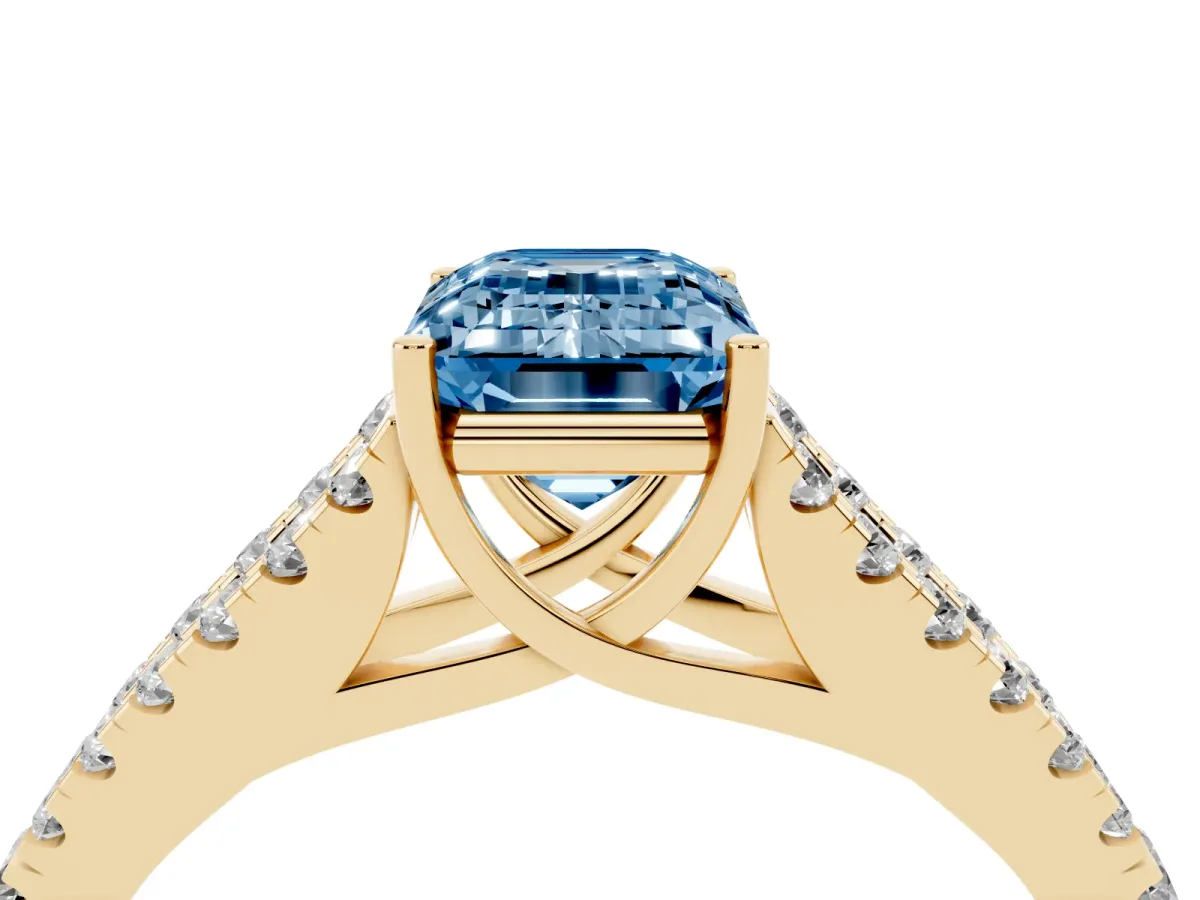 Fancy Blue Emerald Cut Diamond Split Shank Engagement Ring with Round Pavé and Prong Setting Yellow gold