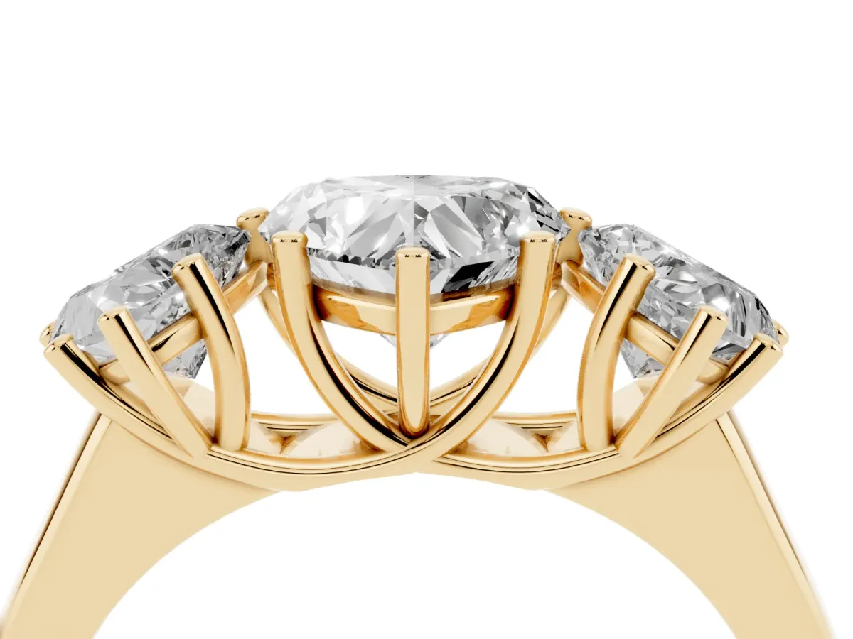 Heart Cut Three-Stone Diamond Ring with Prong Setting on a Classic Band Yellow gold