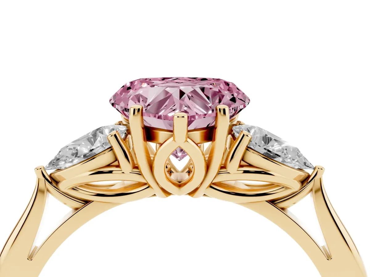 Fancy Pink Three-Stone Heart Cut Diamond Ring with Pear Side Stones in Four-Prong Setting Yellow gold