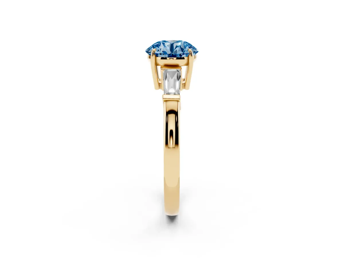 Fancy Blue Round Cut Diamond Three-Stone Ring with Tapered Baguette Side Stones and Prong Setting Yellow gold