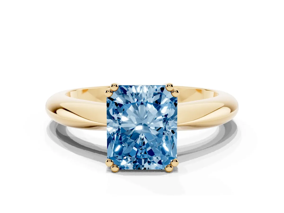 Fancy Blue Radiant Cut Cut Solitaire Engagement Ring with Tapered Band and Four-Prong Setting Yellow gold