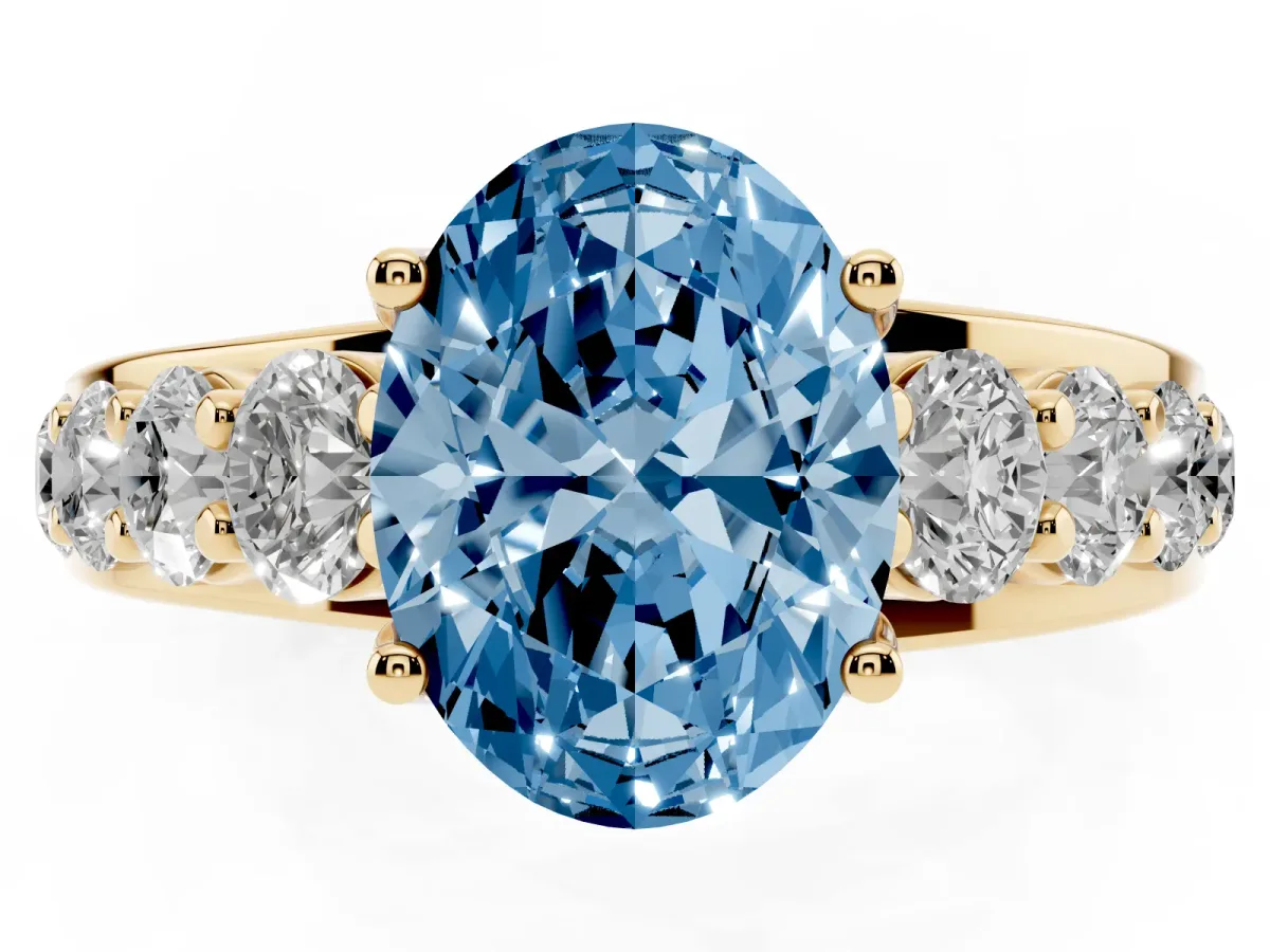 Fancy Blue Oval Cut Diamond Engagement Ring with Pavé Band and Four-Prong Setting Yellow gold