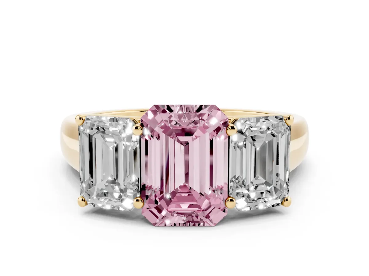Fancy Pink Emerald Cut Three-Stone Diamond Ring with Prong Setting on a Classic Band Yellow gold