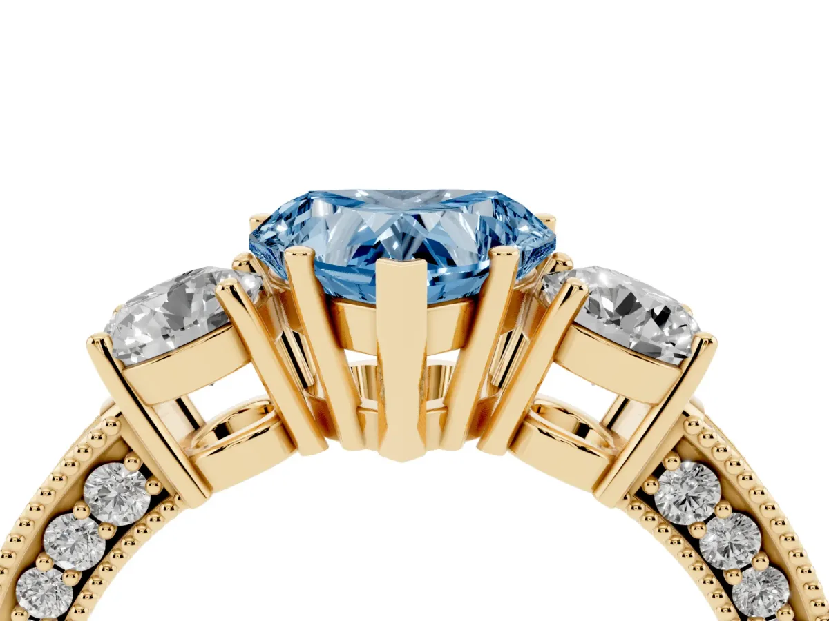 Fancy Blue Heart Cut Three-Stone Diamond Ring with Pavé Band and Four-Prong Setting Yellow gold