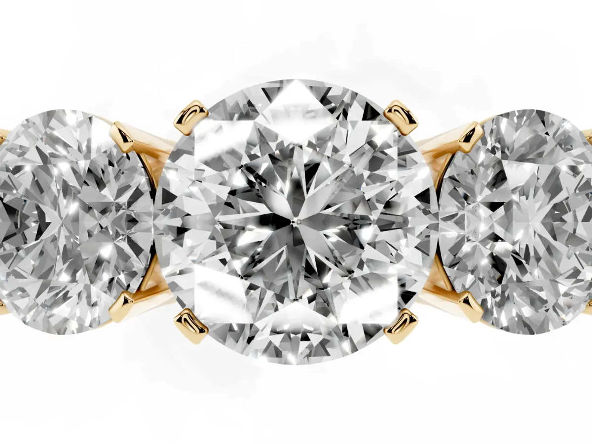 Three-Stone Round Cut Cut Diamond Ring with Channel Set Band and Four-Prong Setting Yellow gold