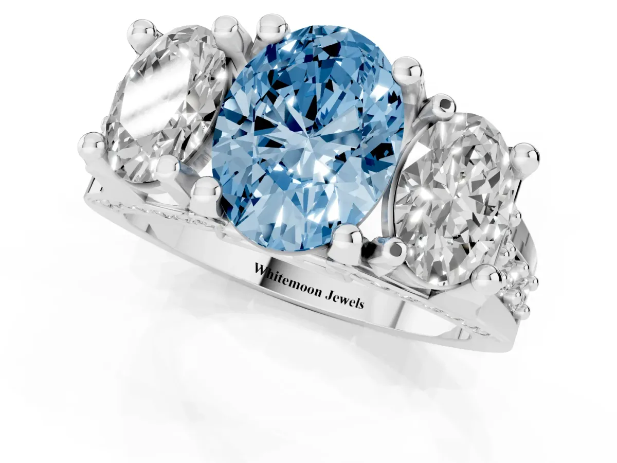 Fancy Blue Oval Cut Diamond Three-Stone Ring with Channel Set Band and Four-Prong Setting Silver
