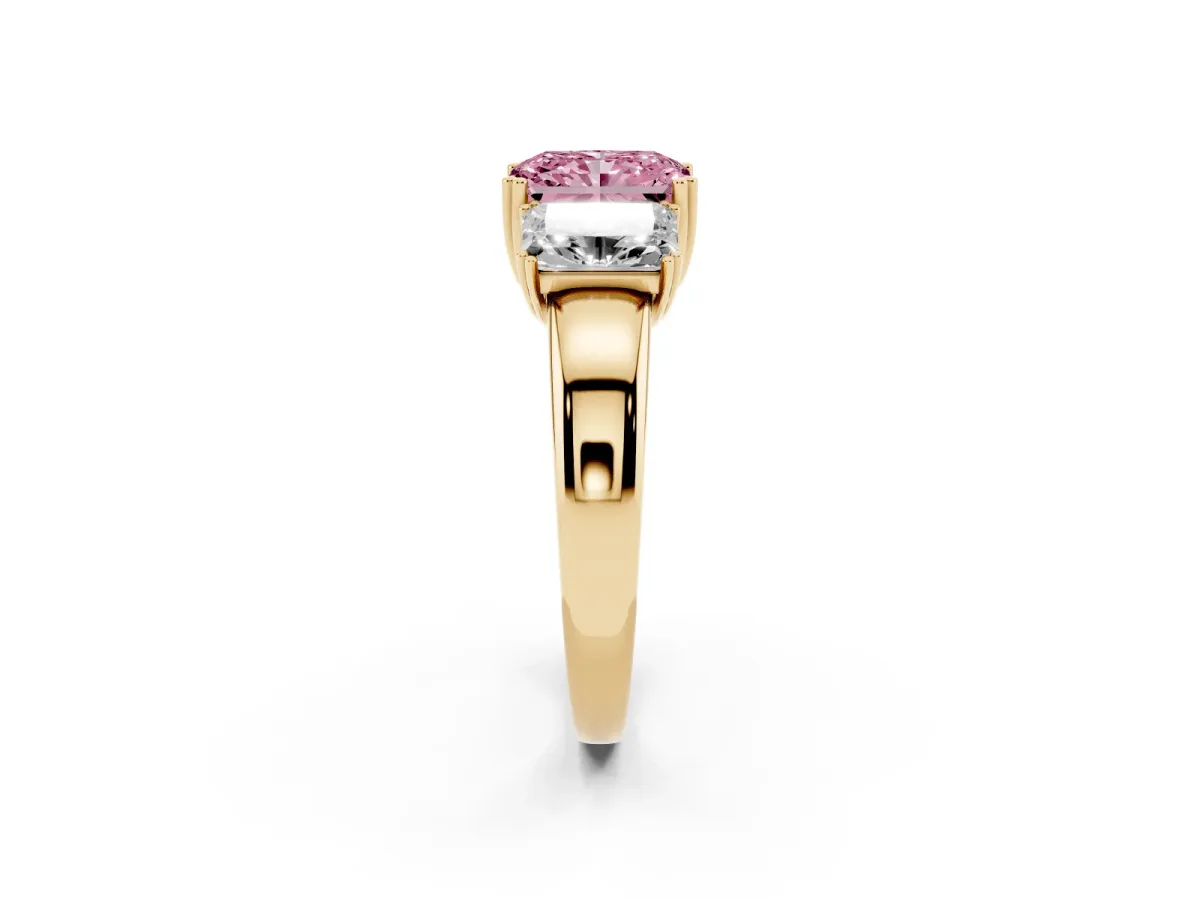 Fancy Pink Three-Stone Radiant Cut Cut Diamond Ring with Channel Set Band and Four-Prong Setting Yellow gold