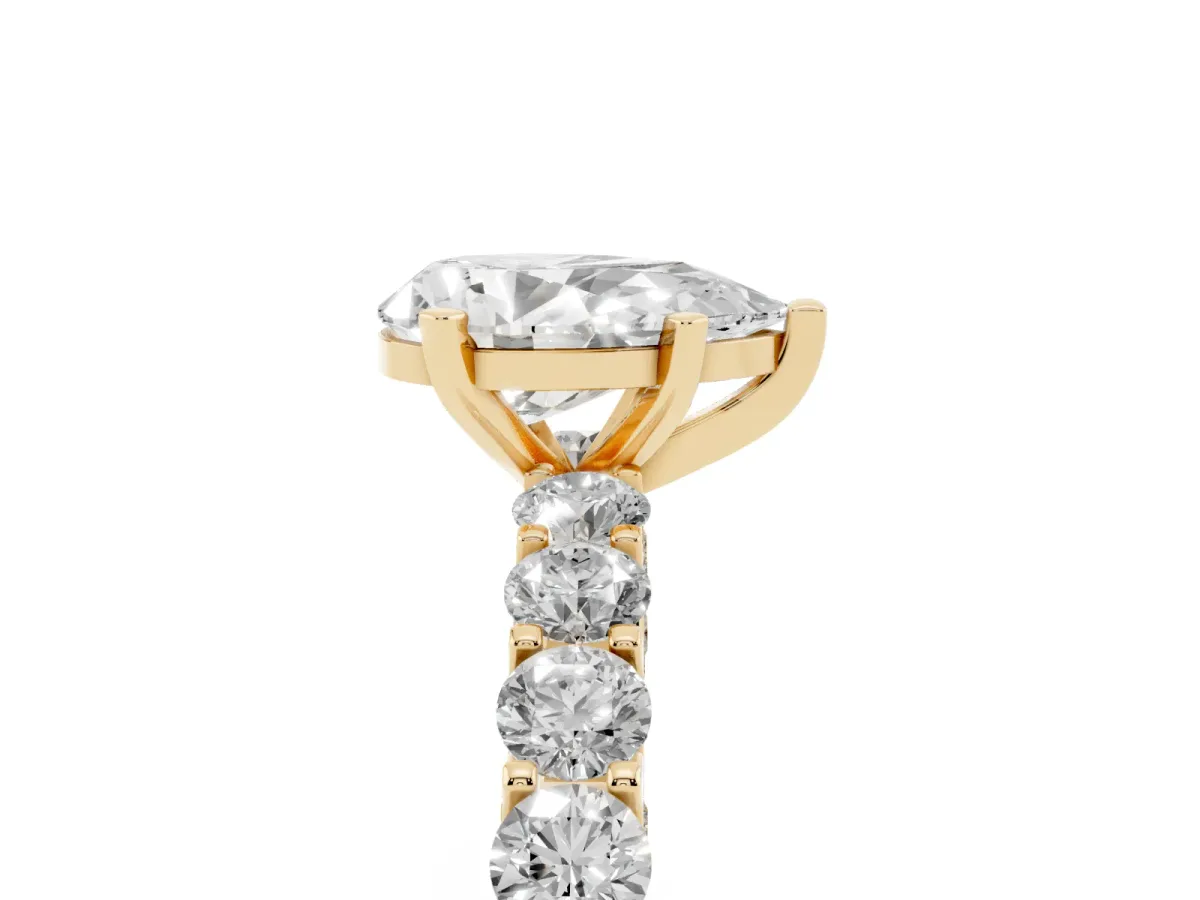 Pear Cut Diamond Solitaire Ring with Shared Prong Pavé Band and Four-Prong Setting Yellow gold