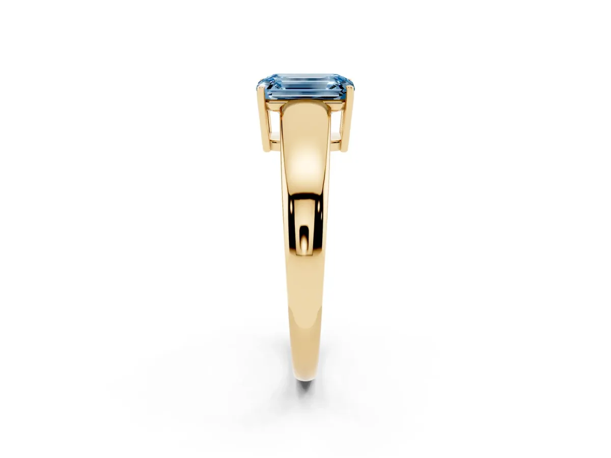Fancy Blue Emerald Cut Solitaire Diamond Ring with Tapered Band and Four-Prong Setting Yellow gold