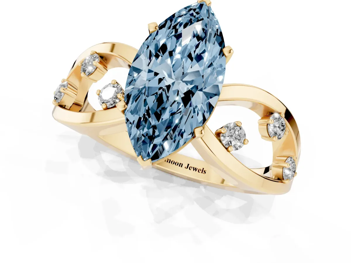 Fancy Blue Marquise Cut Cut Solitaire Diamond with Side Stones on Criss-Cross Band and Four-Prong Setting Yellow gold