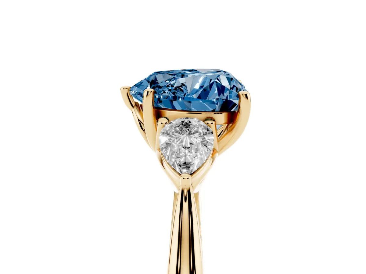 Fancy Blue Three-Stone Heart Cut Brilliant Diamond Solitaire Ring with Tapered Band and Four-Prong Setting Yellow gold