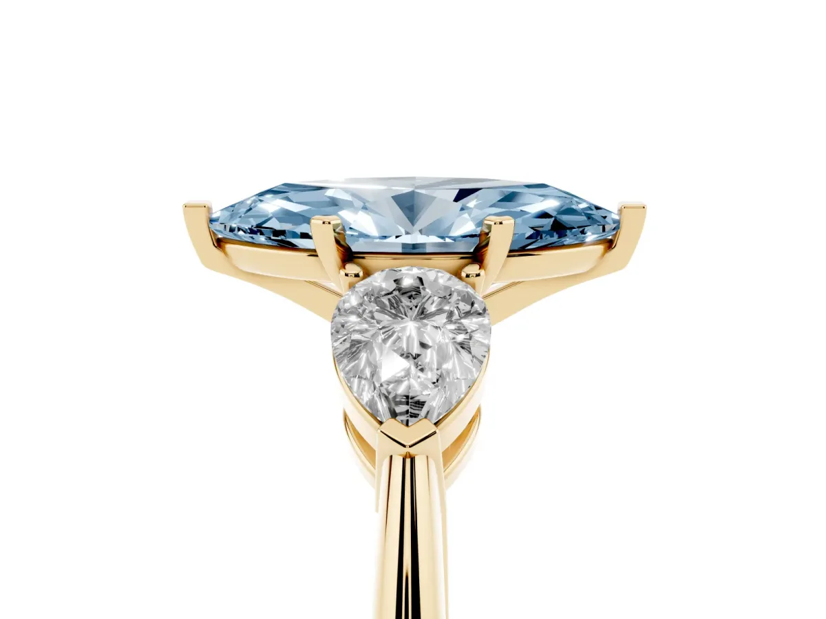 Fancy Blue Three-Stone Marquise Cut Diamond Ring with Pear Side Stones and Four-Prong Setting Yellow gold