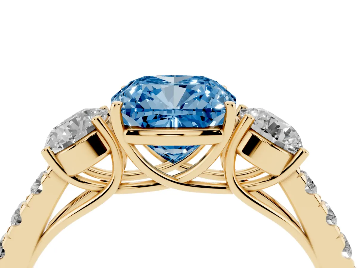 Fancy Blue Cushion Cut Cut Diamond Three-Stone Ring with Round Side Stones and Pavé Band Yellow gold