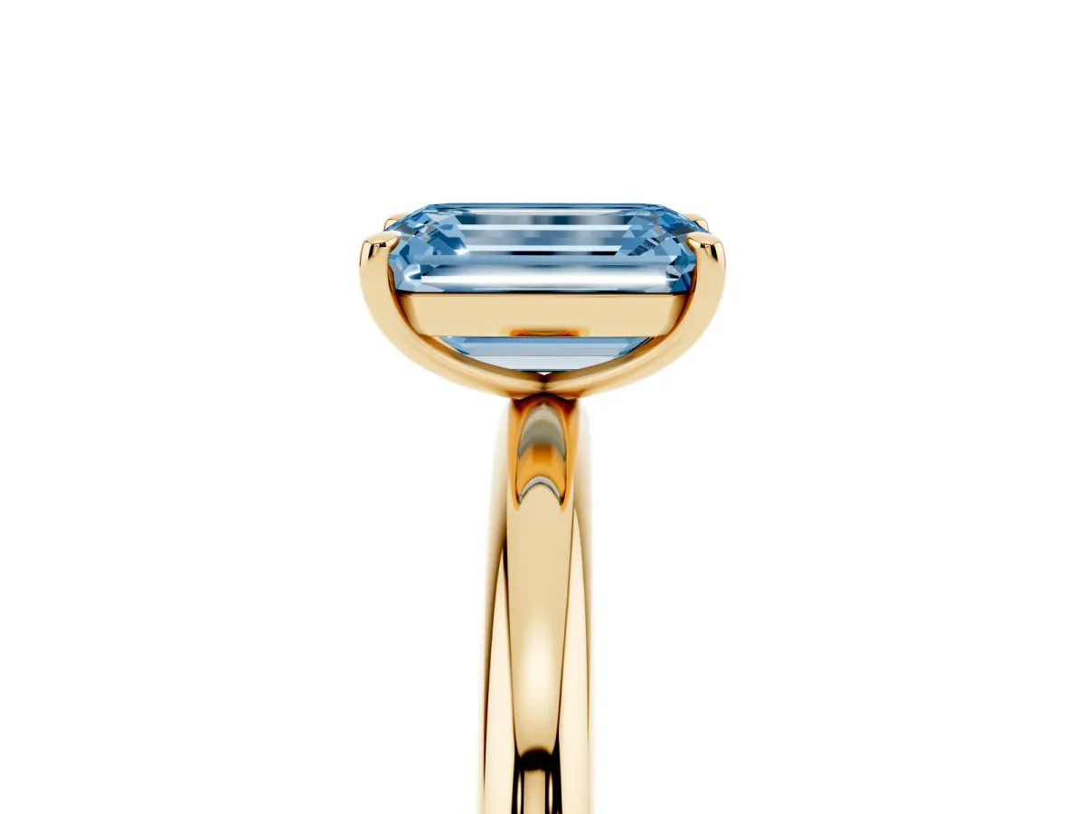 Fancy Blue Emerald Cut Solitaire Diamond Ring with Four-Prong Setting on a Plain Band Yellow gold