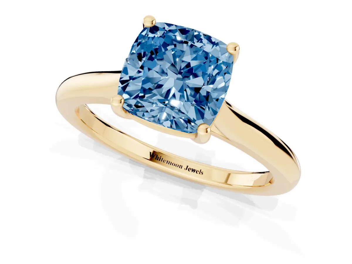 Fancy Blue Cushion Cut Cut Solitaire Ring with Cathedral Band and Four-Prong Setting Yellow gold