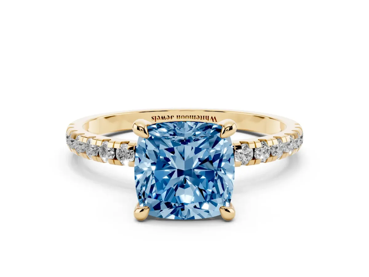 Fancy Blue Cushion Cut Diamond Brilliant Solitaire Ring with Pavé Band and Four-Prong Setting Yellow gold