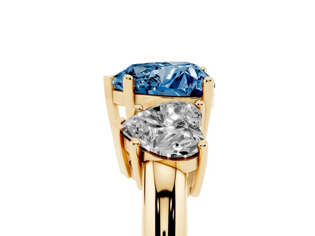 Fancy Blue Three-Stone Heart Cut Cut Diamond Engagement Ring with Prong Setting on a White Gold Band Yellow gold