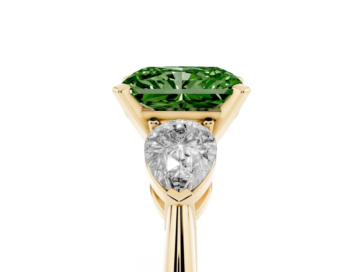 Fancy Green Three-Stone Radiant Cut Diamond Ring with Pear Side Stones and Four-Prong Setting Yellow gold
