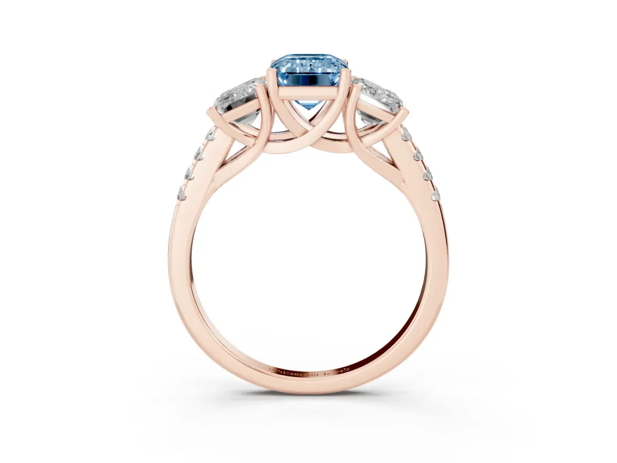 Fancy Blue Three-Stone Emerald Cut Diamond Ring with Round Pavé Band and Prong Setting Rose gold