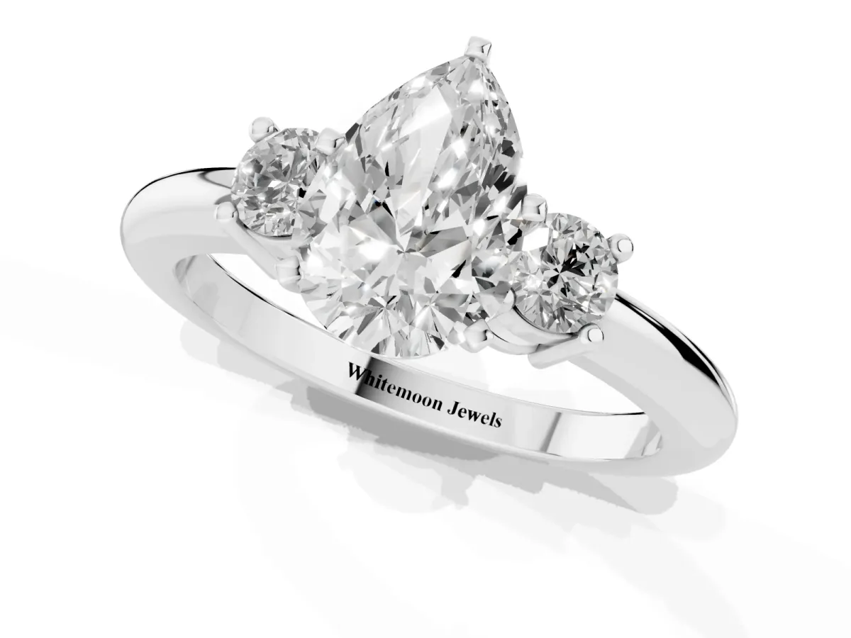 Three-Stone Pear Cut Cut Diamond Solitaire with Prong Setting and Classic Band Platinum