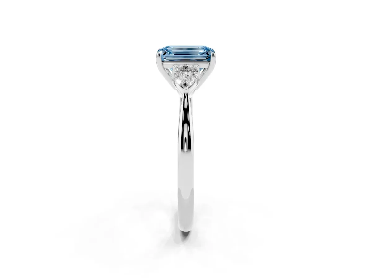 Fancy Blue Three-Stone Emerald Cut Brilliant Diamond Solitaire Ring with Tapered Band and Four-Prong Setting White gold