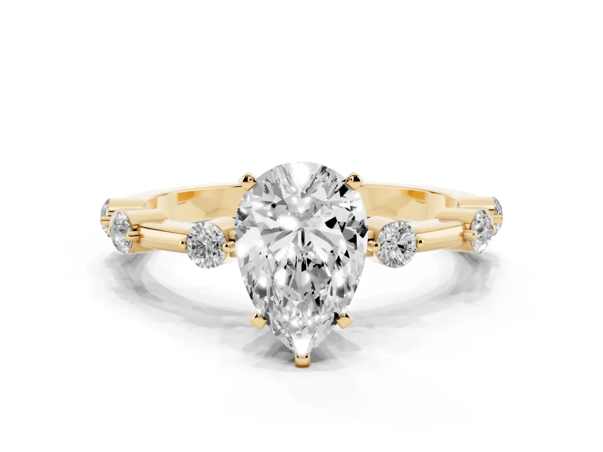 Pear Cut Solitaire Diamond Ring with Bezel Set Side Stones and Prong Setting Yellow gold