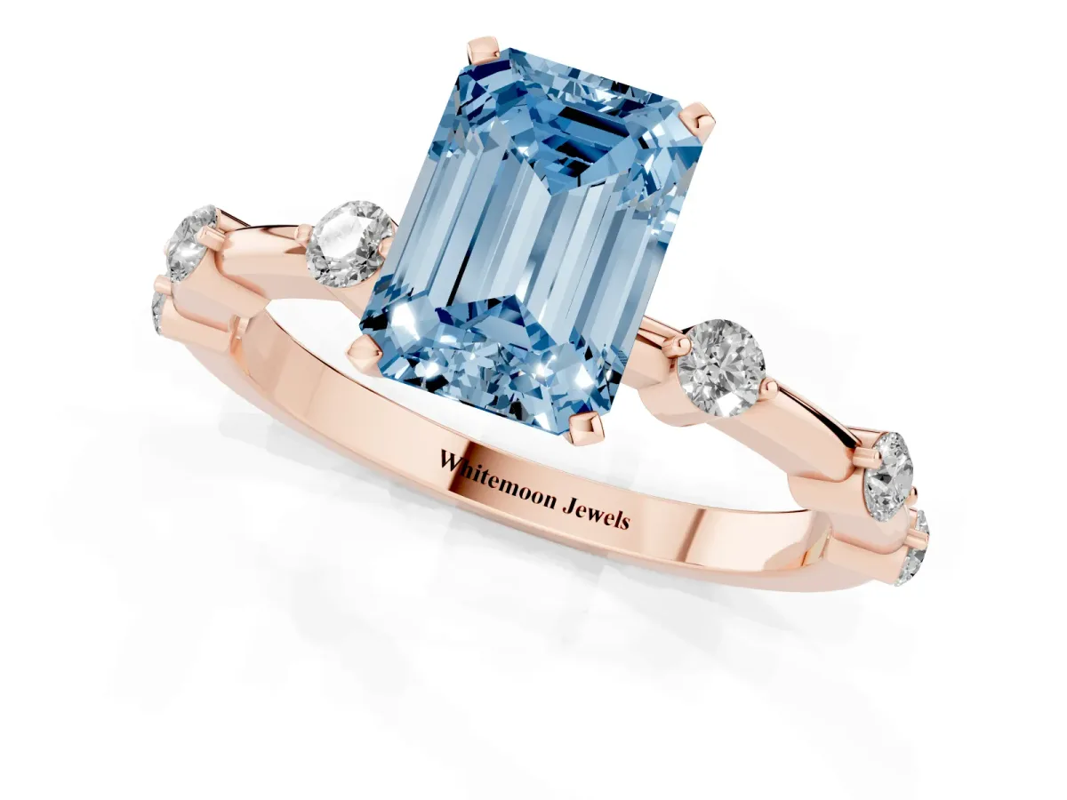 Fancy Blue Emerald Cut Solitaire Diamond Ring with Bezel Set Side Stones and Prong Setting Rose gold