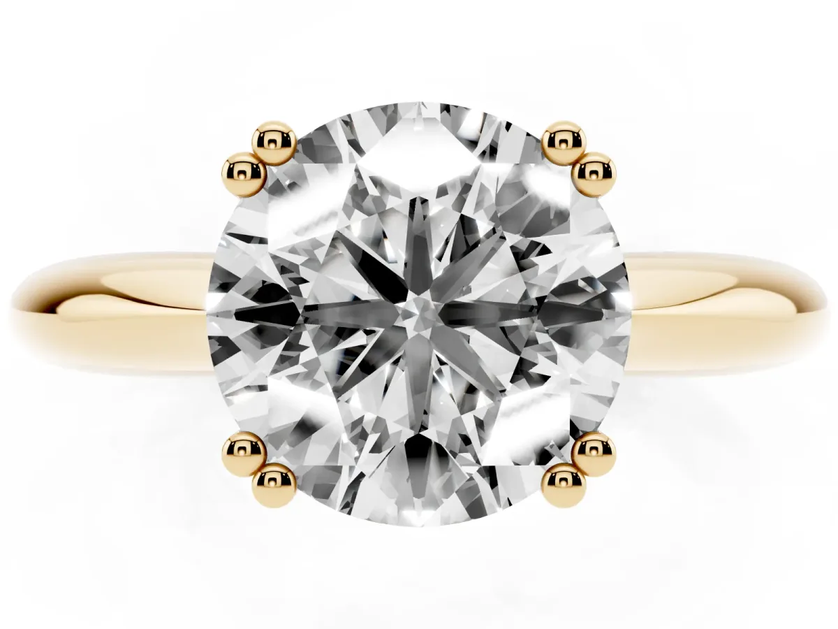 Round Cut Cut Solitaire Engagement Ring with Tapered Band and Four-Prong Setting Yellow gold