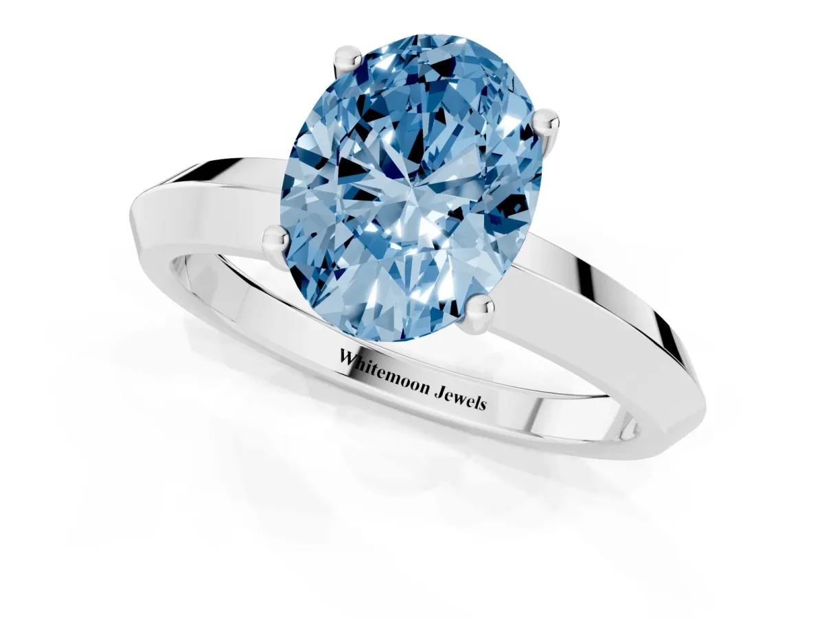 Fancy Blue Oval Cut Cut Solitaire Engagement Ring with Flat Band and Four-Prong Setting Platinum