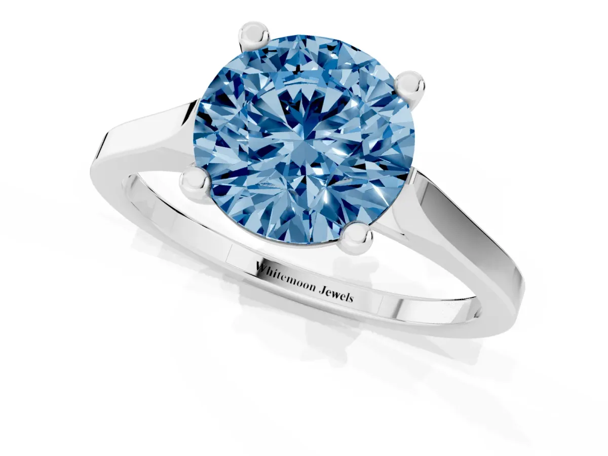 Fancy Blue Round Cut Solitaire Diamond Ring with Four-Prong Setting and Tapered Band Platinum