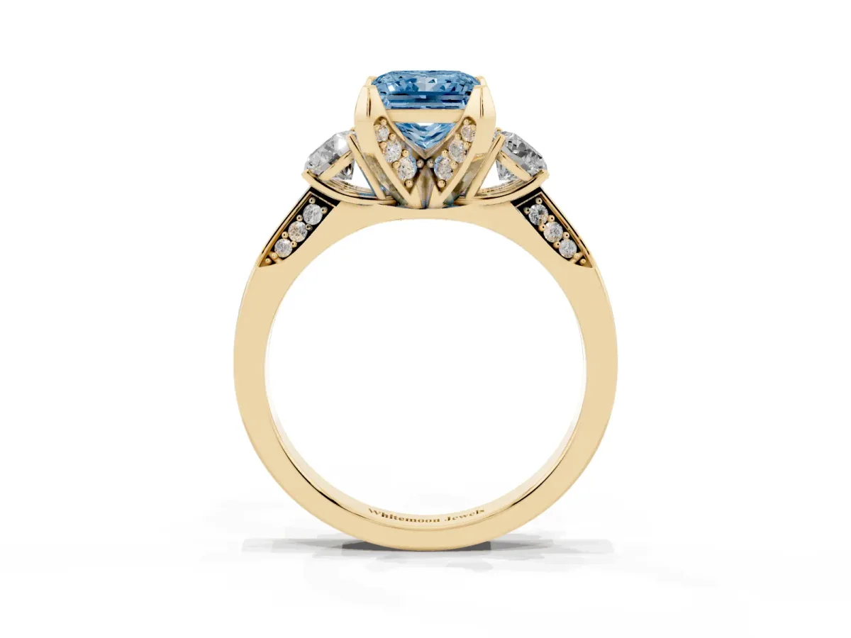 Fancy Blue Princess Cut Brilliant Three-Stone Diamond Ring with Pavé Band and Four-Prong Setting Yellow gold