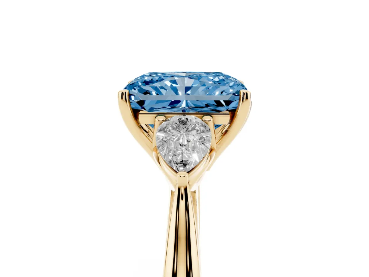 Fancy Blue Radiant Cut Diamond Three-Stone Ring with Pear Side Stones and Prong Setting Yellow gold