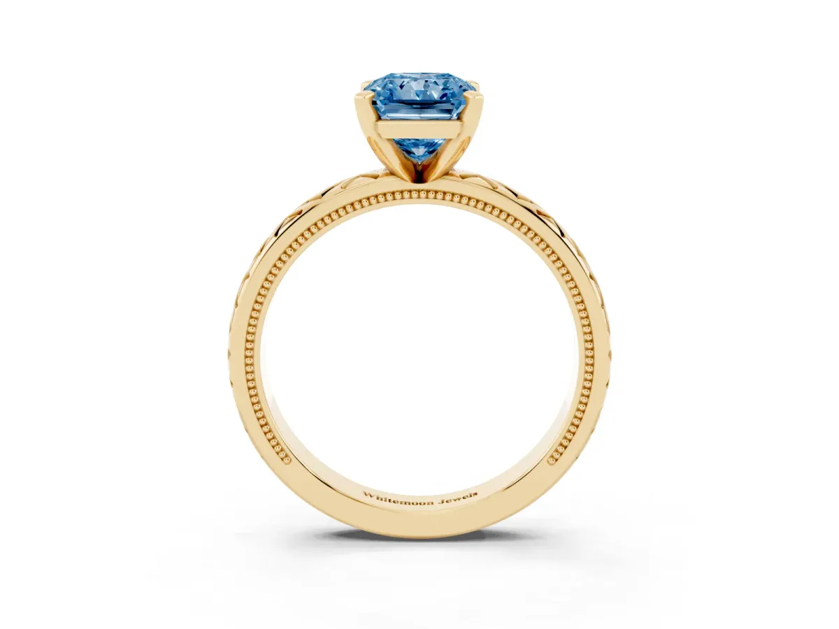 Fancy Blue Radiant Cut Solitaire Diamond Ring with Milgrain and Black Enamel X Pattern Band Yellow gold