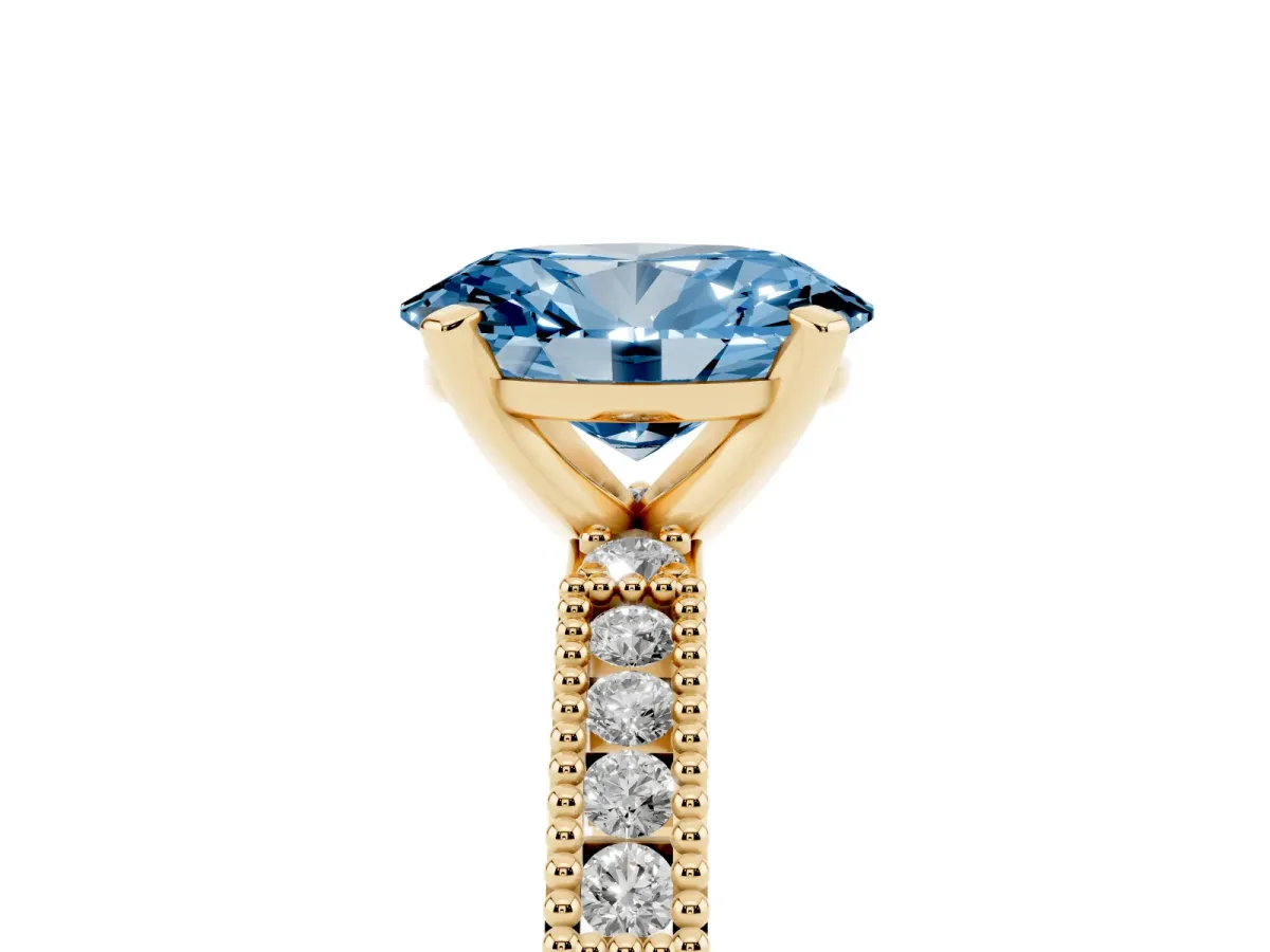 Fancy Blue Oval Cut Solitaire with Pavé Band and Four-Prong Setting Yellow gold