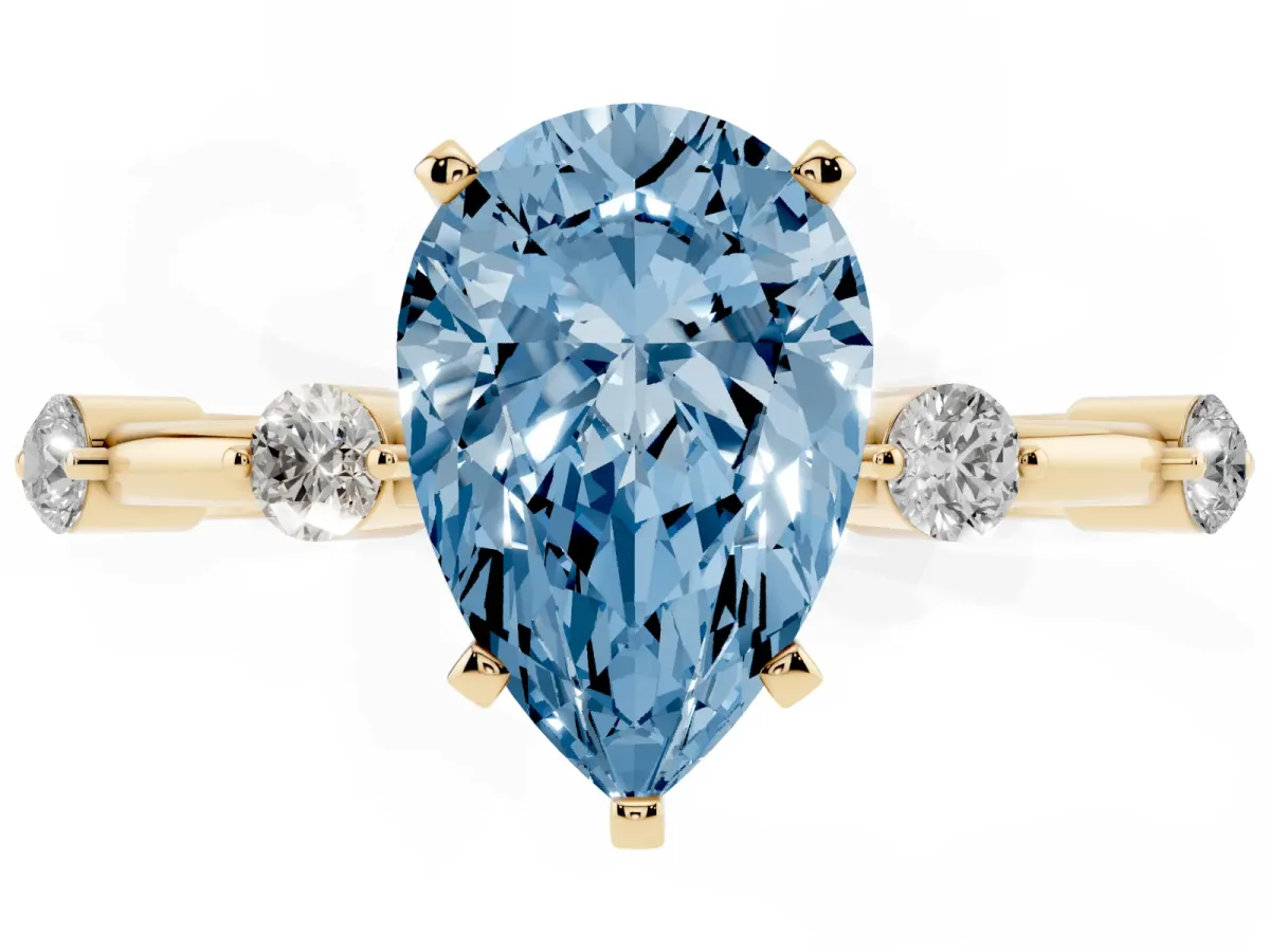 Fancy Blue Pear Cut Solitaire Diamond Ring with Bezel Set Side Stones and Prong Setting Yellow gold