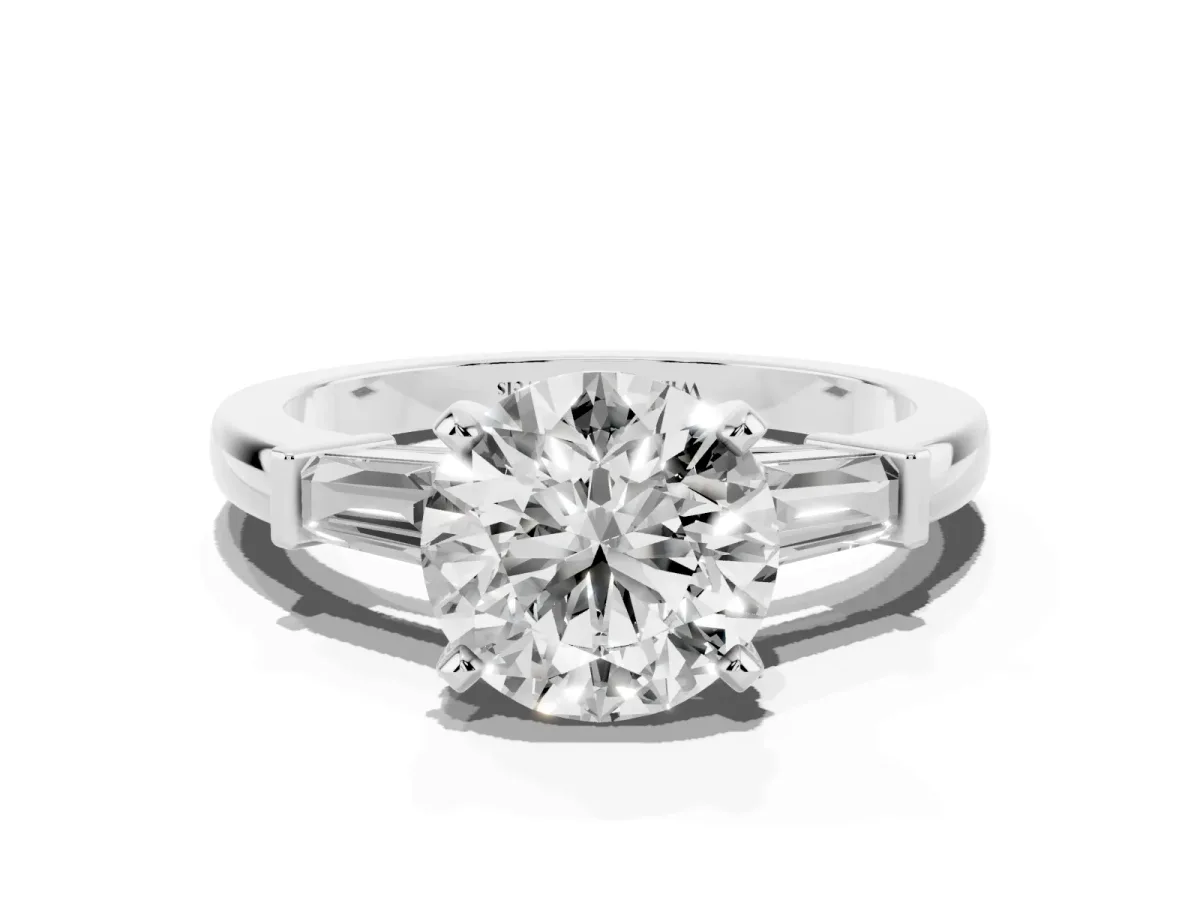 Round Cut Cut Diamond Solitaire Ring with Tapered Baguette Accents and Four-Prong Setting White gold