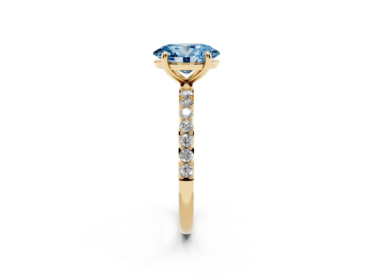 Fancy Blue Oval Cut Diamond Solitaire Ring with Round Pavé Band and Prong Setting Yellow gold