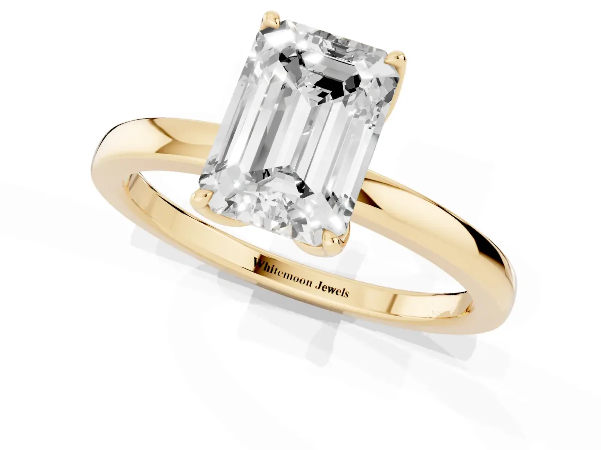 Emerald Cut Diamond Solitaire Ring with Thin Band and Prong Setting Yellow gold