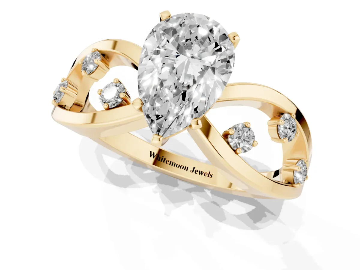 Pear Cut Cut Solitaire Diamond with Side Stones on Criss-Cross Band and Four-Prong Setting Yellow gold