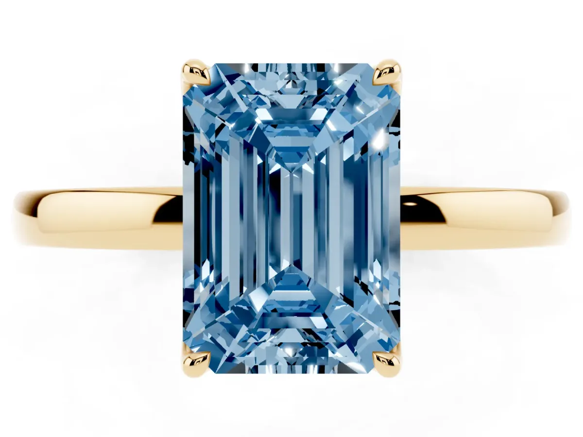 Fancy Blue Emerald Cut Diamond Solitaire Ring with Thin Band and Prong Setting Yellow gold