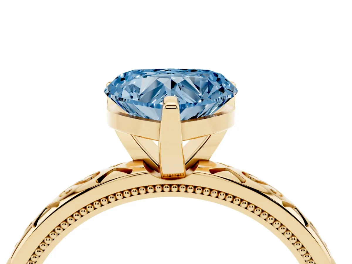 Fancy Blue Heart Cut Solitaire Engagement Ring with Scrollwork Band and Four-Prong Setting Yellow gold