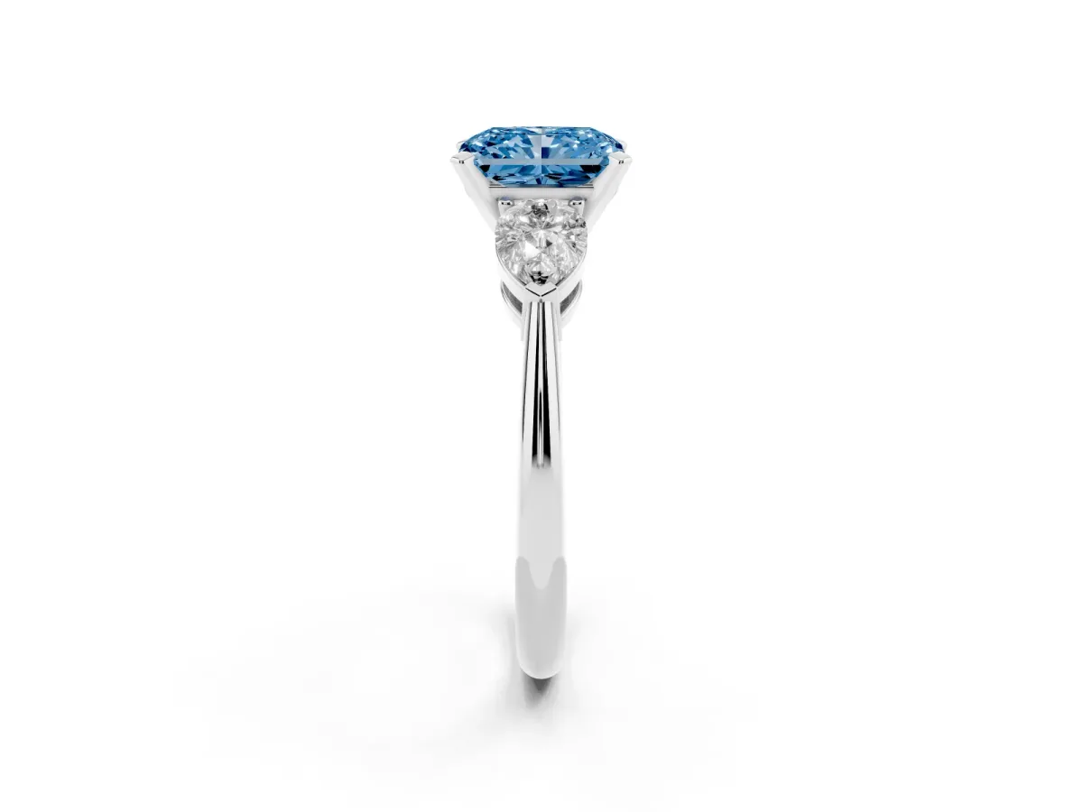 Fancy Blue Three-Stone Radiant Cut Diamond Ring with Pear Side Stones and Four-Prong Setting Platinum