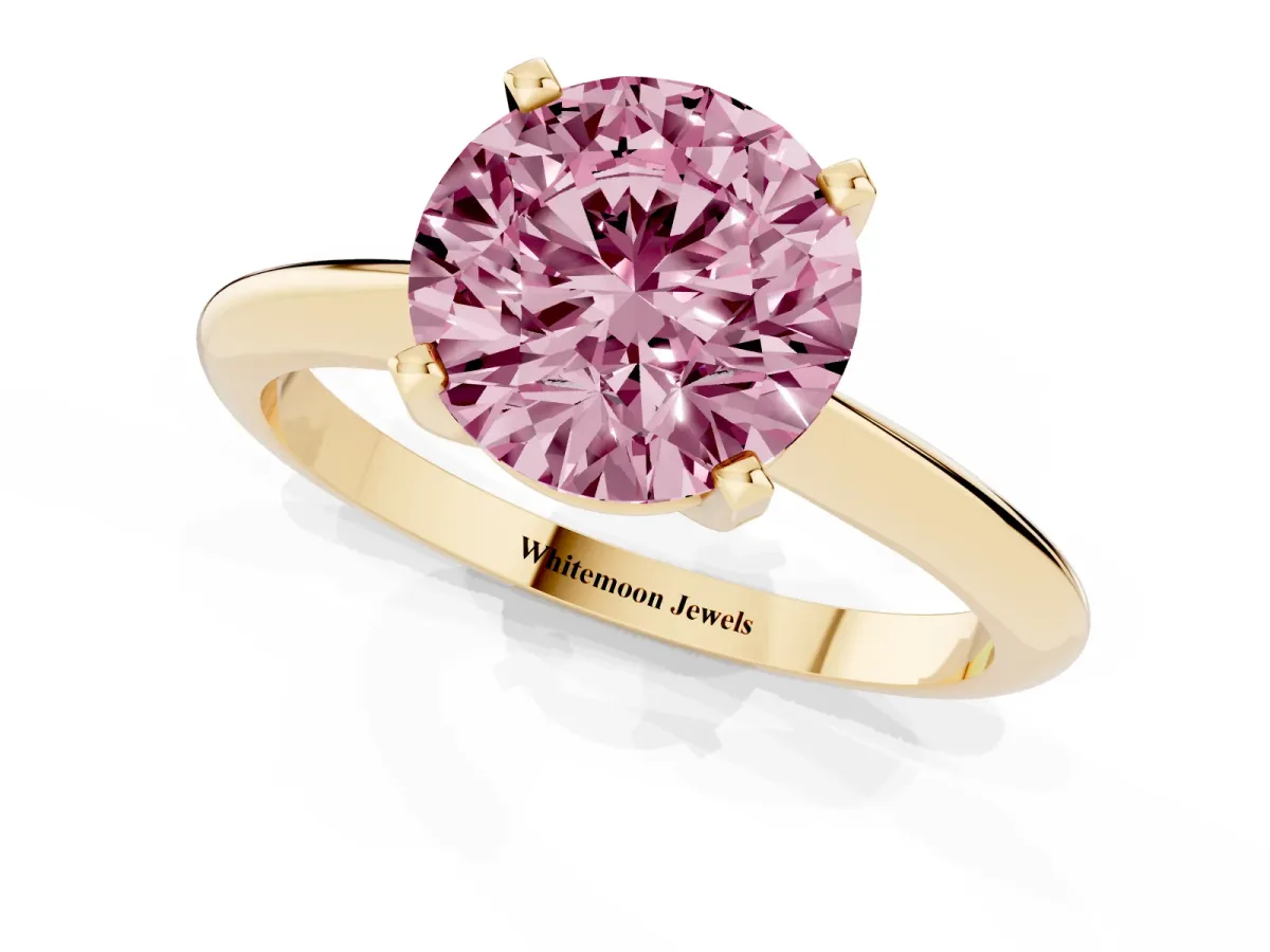 Fancy Pink Round Cut Cut Solitaire Ring with Four-Prong Setting on a Classic Band Yellow gold