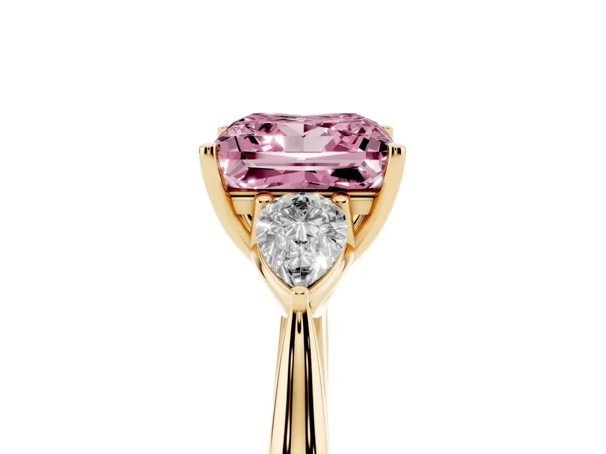 Fancy Pink Three-Stone Princess Cut Diamond Ring with Pear Side Stones in Four-Prong Setting Yellow gold